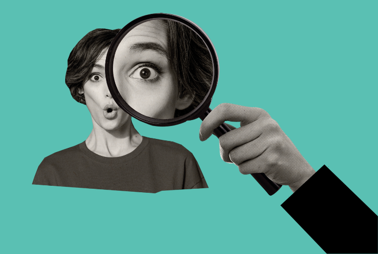 Black and white image of a woman looking through a large magnifying glass on a light green background